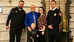Saginaw Township, MI, Police Det. Andrew Keller (from left), Justin Severs and his son Carter, 5, and wife Kelley Severs, and Saginaw firefighter Brandon Hausbeck.