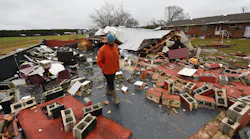 Residents in Lawrence County, AL, walk through the destruction caused by powerful storms and suspected tornadoes that tore through the Deep South on Monday.