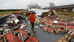 Residents in Lawrence County, AL, walk through the destruction caused by powerful storms and suspected tornadoes that tore through the Deep South on Monday.