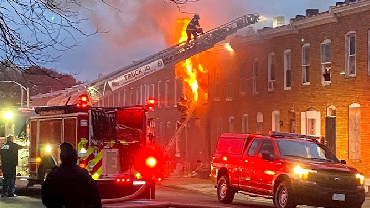 Baltimore firefighters battle a fire on South Bentalou Street Friday afternoon. This was one of four fires in less than two hours in one Southwest Baltimore neighborhood.
