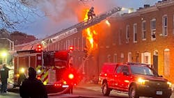 Baltimore firefighters battle a fire on South Bentalou Street Friday afternoon. This was one of four fires in less than two hours in one Southwest Baltimore neighborhood.