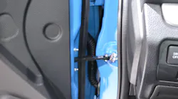The front door of a 2020 Subaru CrossTrek has—as is the case on the doors of most new automobiles—four points of attachment to the vehicle: two hinges, a wiring harness and a door-retainer bar.