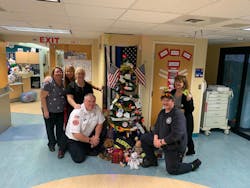 Gardner firefighters with nurses and staff at UMass Worcester after delivering over 400 teddy bears.