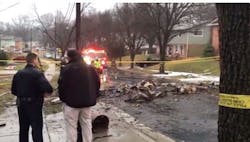 Officials gather at the scene after a plane crashed into a New Carrollton home Sunday. Officials gather at the scene after a plane crashed into a New Carrollton home Sunday.