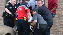Firefighters, police and paramedic remove a victim from the scene of a shooting at a White Settlement church Sunday morning.
