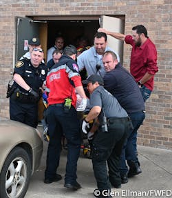 Firefighters, police and paramedic remove a victim from the scene of a shooting at a White Settlement church Sunday morning. Firefighters, police and paramedic remove a victim from the scene of a shooting at a White Settlement church Sunday morning.