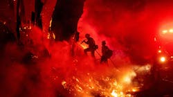 Firefighters work to control flames from a backfire during the Maria fire Nov. 1 in Santa Paula, CA.