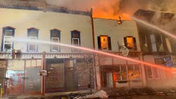 Firefighters from Boonviille, NY, and six other departments battle an overnight blaze that burned at least three buildings Tuesday and displaced multiple families.
