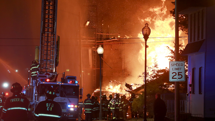 A massive seven-alarm fire tore through unoccupied buildings in Bound Brook late Sunday.