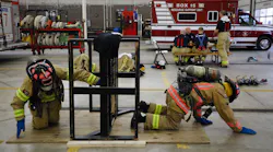 Columbus, OH, Division of Fire recruits Aaron Peaks (right) and Cassie Mays practice crawling through walls during training Friday at the Columbus Fire Training Academy. The division recently acquired new firefighting clothing designed specifically to reduce carcinogenic exposure along with other toxins.