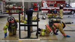 Columbus, OH, Division of Fire recruits Aaron Peaks (right) and Cassie Mays practice crawling through walls during training Friday at the Columbus Fire Training Academy. The division recently acquired new firefighting clothing designed specifically to reduce carcinogenic exposure along with other toxins. Columbus, OH, Division of Fire recruits Aaron Peaks (right) and Cassie Mays practice crawling through walls during training Friday at the Columbus Fire Training Academy. The division recently acquired new firefighting clothing designed specifically to reduce carcinogenic exposure along with other toxins.