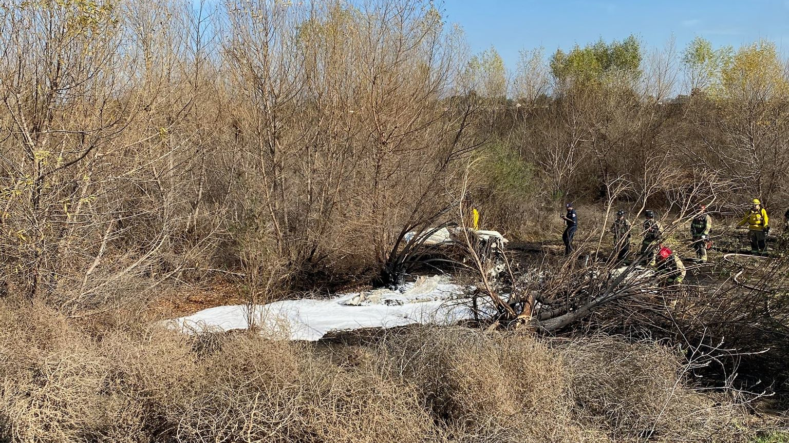 Corona, CA, firefighters put out the flames of a fiery airplane crash that killed four people Thursday.