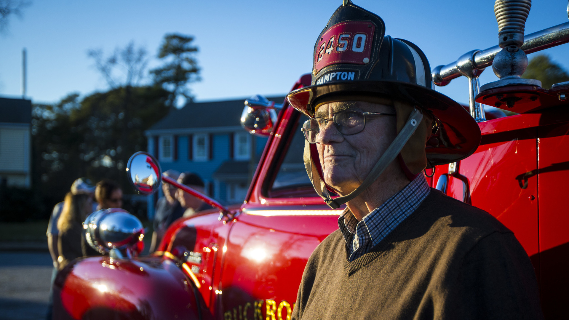 Robert J. Smith dons his firefighter's helmet at his 90th birthday Saturday in Hampton, VA. Smith began his career as a firefighter before firefighters wore oxygen tanks as they do now.