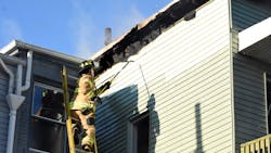 A Jersey City, NJ, firefighter works on a ladder during a three-alarm blaze at a two-family home on Jan. 21, 2020. A Jersey City, NJ, firefighter works on a ladder during a three-alarm blaze at a two-family home on Jan. 21, 2020.
