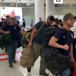 U.S. firefighters are welcomed with applause after landing in Sydney on Thursday. The group is part of about 100 firefighters who will be helping to battle the devastating wildfires raging across Australia.