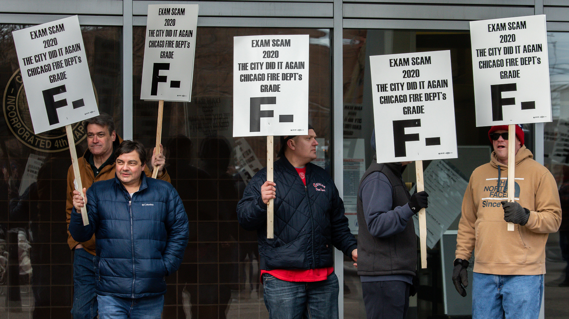 Chicago firefighters rally in front of the city's public safety headquarters in protest of problems during a recent promotional exam.