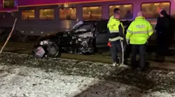 Two Ashland, MA, firefighters pulled several men out of the way of an oncoming train after their car became stuck Thursday night.