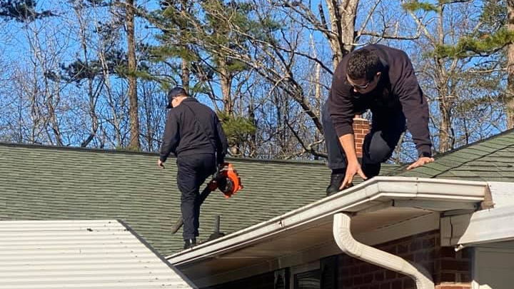 Gastonia, NC, firefighters cleaned out the gutters for a man who they had earlier rescued from him from his roof.