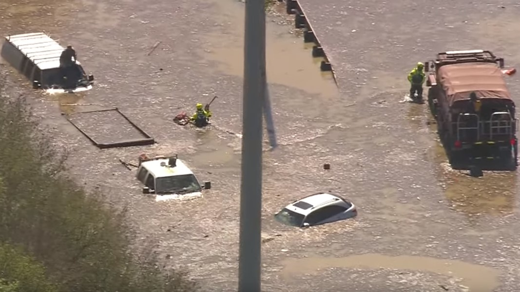 Houston firefighters rescue stranded motorists after a massive water main break Thursday.