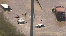 Houston firefighters rescue stranded motorists after a massive water main break Thursday.