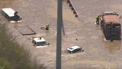 Houston firefighters rescue stranded motorists after a massive water main break Thursday. Houston firefighters rescue stranded motorists after a massive water main break Thursday.