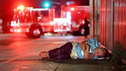 A homeless man sleeps outside Los Angeles City Fire Department Station No. 9, the busiest station in the country.