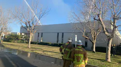 More than 100 Orange County, CA, Fire Authority firefighters battled a massive four-alarm blaze that broke out a nonprofit's warehouse headquarters in Irvine on Sunday.