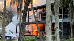 Firefighters from multiple departments kept at a safe distance as ammunition went off while they doused a burning house with water Sunday.