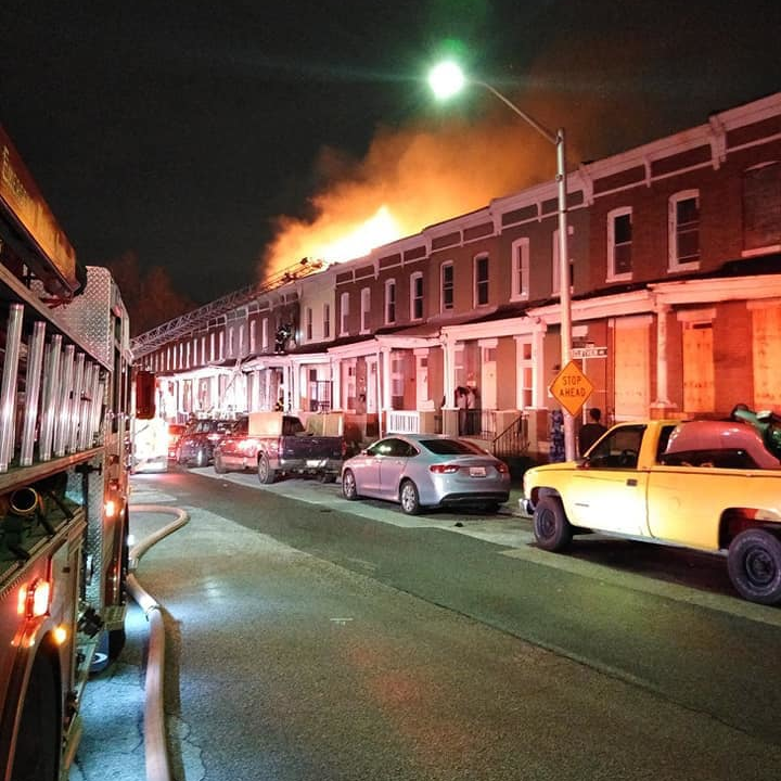 Four Baltimore City firefighters were rescued from the basement of a burning two-story row house Wednesday after the building's first floor collapsed.