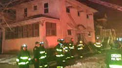 Chicago firefighters remain on scene after knocking down a residential fire and saving a man who had escaped to the roof on Wednesday, Feb. 12, 2020.