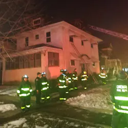 Chicago firefighters remain on scene after knocking down a residential fire and saving a man who had escaped to the roof on Wednesday, Feb. 12, 2020.