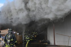 An open bay door in the rear of the building fed the fire all of the air that it needed to quickly expand beyond the capabilities of handlines. An open bay door in the rear of the building fed the fire all of the air that it needed to quickly expand beyond the capabilities of handlines.