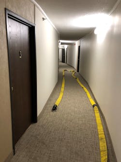 Once at the fire apartment, the nozzle team must ensure that the working length of hose is present with the nozzle and coupling at the door. For most apartments, 50 feet of hose should be adequate.
