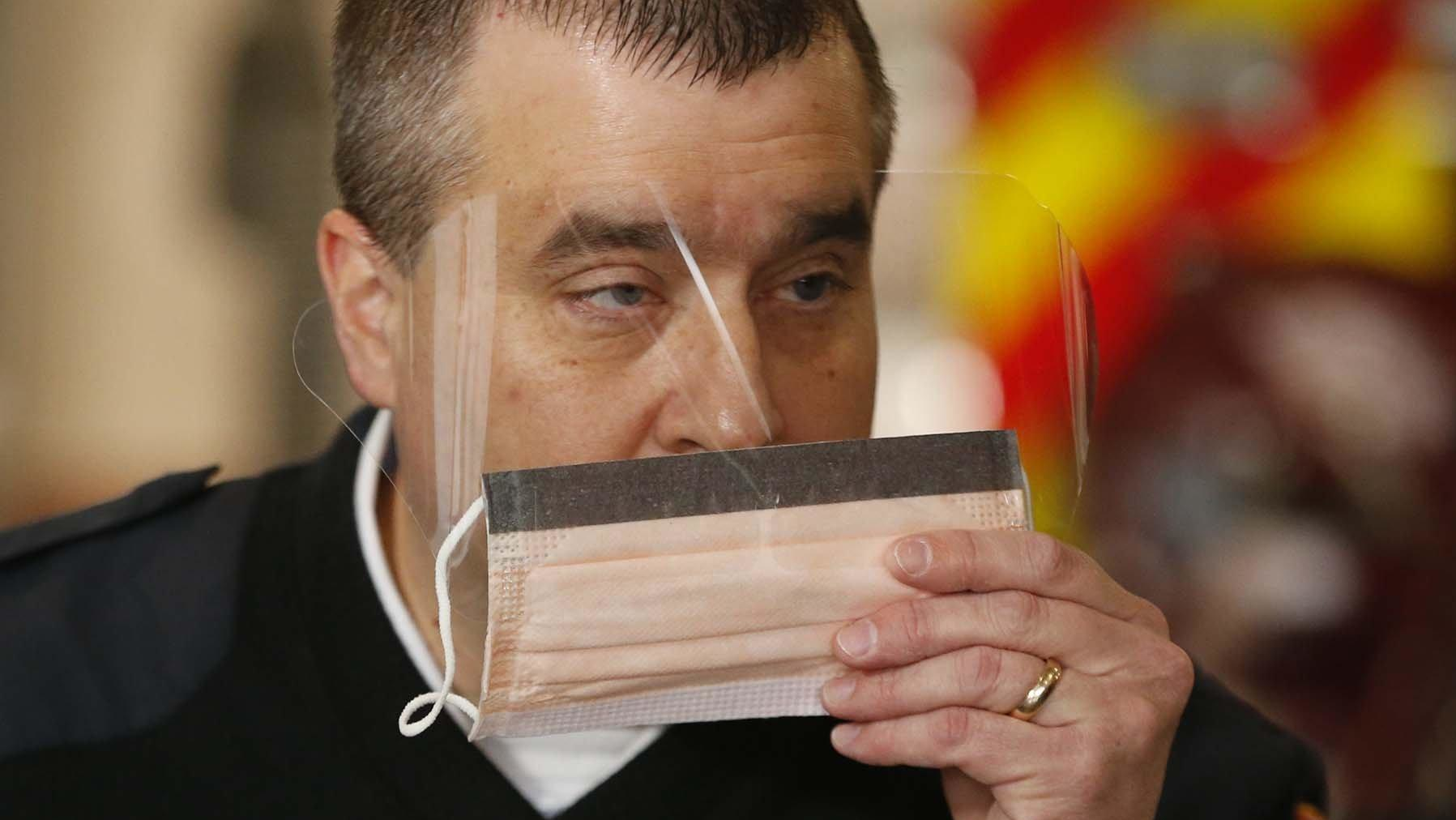 Green, OH, Fire Chief Jeff Funai shows the surgical mask that EMS personnel will wear when dealing with a COVID-19 patient.