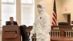 An EMS staffer in Florida demonstrates the protective gear used by hospital workers and first responders when treating a coronavirus patient. An EMS staffer in Florida demonstrates the protective gear used by hospital workers and first responders when treating a coronavirus patient.