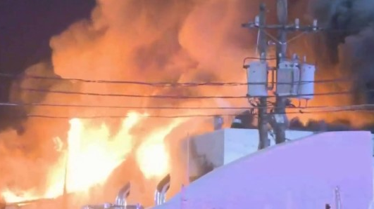 A firefighter was injured late Sunday battling a massive blaze at a truck repair shop in Elizabeth, NJ.
