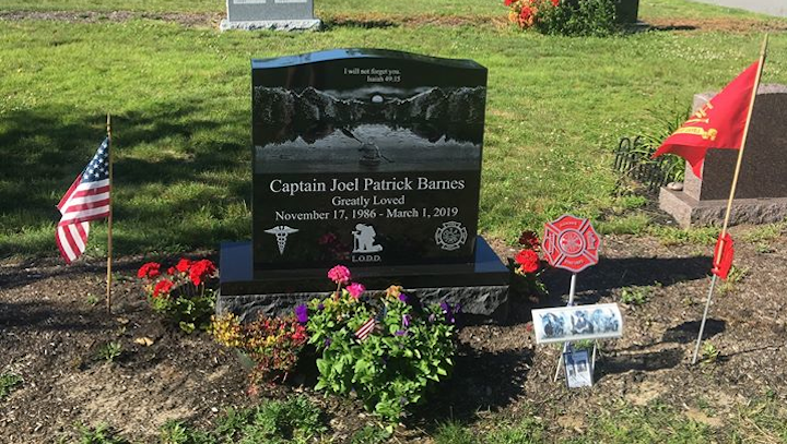The grave site of Berwick, MA, Fire Capt. Joel Barnes, who died last year battling an apartment fire.