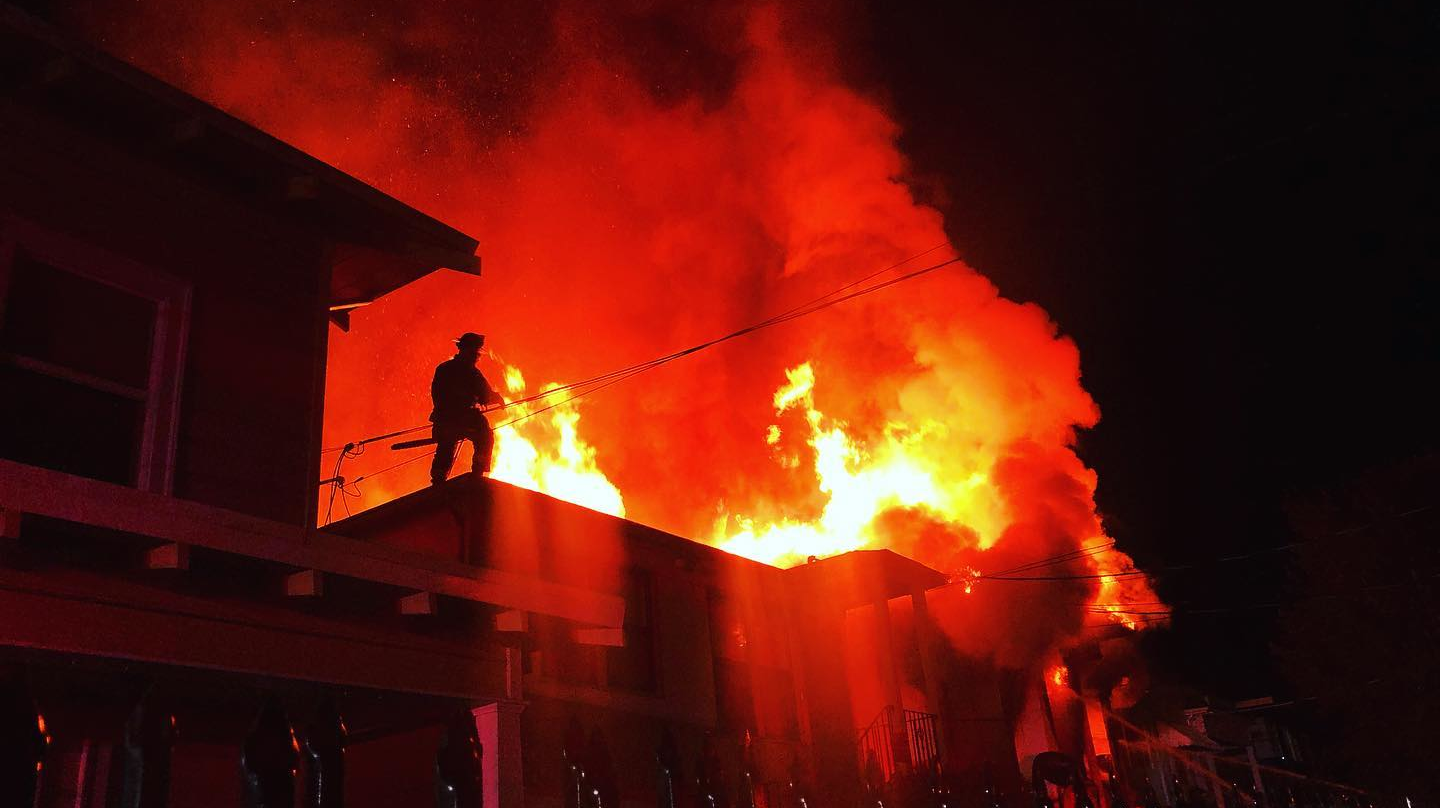 An Oakland, CA, firefighter works to douse flames during a two-alarm fire that broke out at a vacant home in the city's Fruitvale district early Thursday.