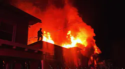 An Oakland, CA, firefighter works to douse flames during a two-alarm fire that broke out at a vacant home in the city's Fruitvale district early Thursday.