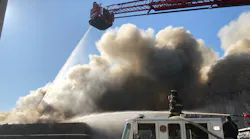 Firefighters battled a four-alarm blaze at a Paterson, NJ, auto shop that could be seen 20 miles away Monday.
