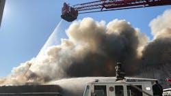 Firefighters battled a four-alarm blaze at a Paterson, NJ, auto shop that could be seen 20 miles away Monday. Firefighters battled a four-alarm blaze at a Paterson, NJ, auto shop that could be seen 20 miles away Monday.