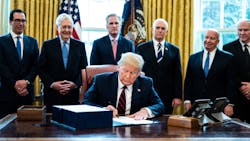 President Donald Trump signs H.R. 748, a $2 trillion economic stimulus bill that will try to help counteract the disruption caused by the COVID-19 pandemic.