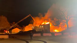Firefighters battle a raging blaze at the former South Weymouth, MA, Naval Air Station early Friday.