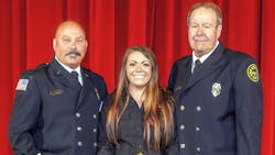Three generations of Janesville firefighters. From left, Chris Lloyd, McKayla Gates-Lloyd and Gary Lloyd pose at McKayla&apos;s academy graduation ceremony in March 2019.
