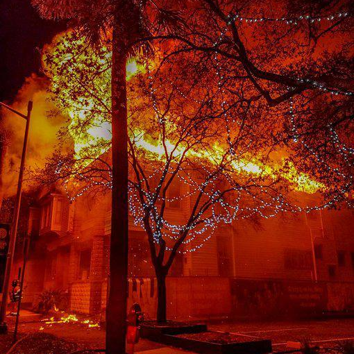 Flames engulfs the roof of an abandoned home as Jacksonville, FL, firefighters began battling it early Monday.