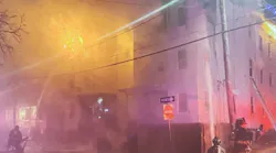 Firefighters from Lynn, MA, and the surrounding area battled a blaze that broke out at a triple-decker house late Wednesday and spread to a nearby building.