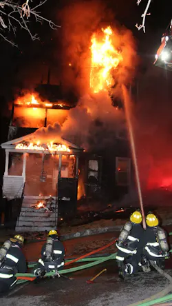 Worcester, MA, firefighters douse the flames of a burning home early Thursday.