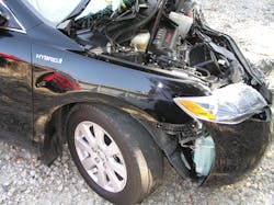 For its 2007 model-year Toyota Camry Hybrid, the automaker employed three-sided badging. Fortunately for responders at this incident, the passenger side hybrid badge remained intact.