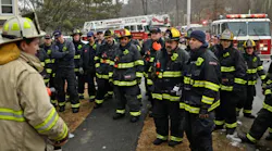 Under new protocol, firefighters listen to comments by a chief after they fought a 2-alarm fire at 63 Overlook Drive in Worcester. The fire displaced about 30 people on Feb. 18.