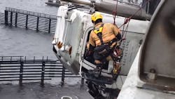 A Chesapeake, VA, firefighter rappels down the side of a bridge to rescue a truck driver whose tractor-trailer cab was hanging 70 feet above the Elizabeth River after a crash Monday. A Chesapeake, VA, firefighter rappels down the side of a bridge to rescue a truck driver whose tractor-trailer cab was hanging 70 feet above the Elizabeth River after a crash Monday.